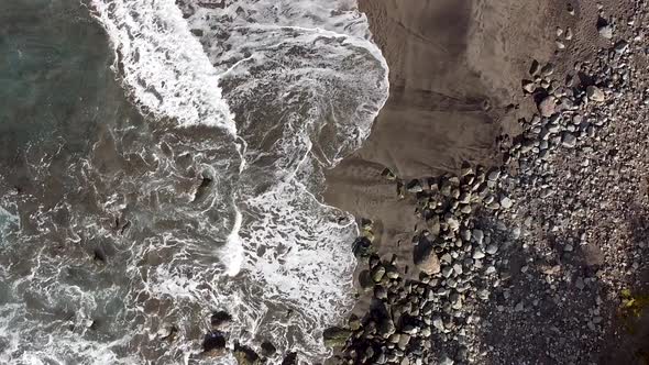 Top-down aerial drone view of a rugged beach in Northern Tenerife, Anaga National Park.