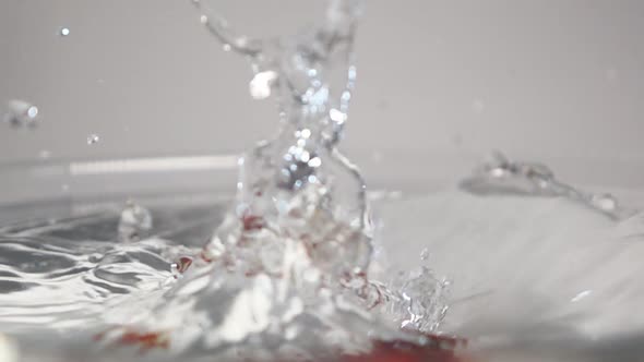 Three Strawberries Drop Into Water