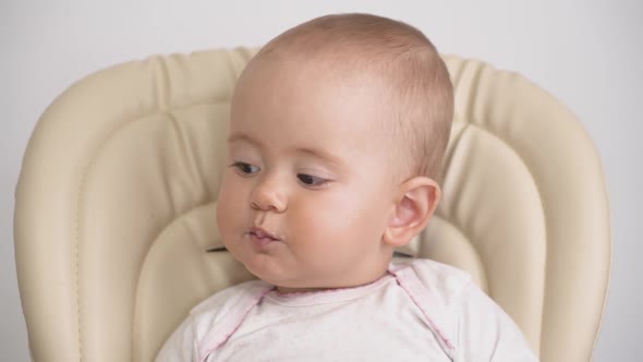 Mom Feeds The Baby With A Spoon Hd