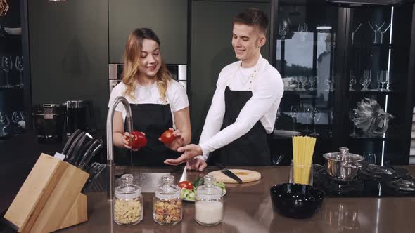 Couple Washing Vegetables in Kitchen Close Up