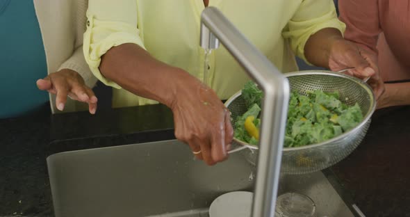 Senior diverse people cooking in kitchen at retirement home