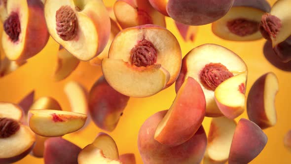 Super Slow Motion Shot of Peach Cuts Flying Towards Camera on Orange Background at 1000 Fps