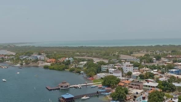 Drone flying along Las Calderas bay, Bani in Dominican Republic. Aerial forward. Sky for copy space