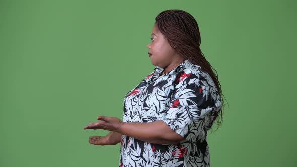 Overweight Beautiful African Woman Against Green Background