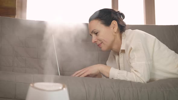 Ultrasonic humidifier by woman.