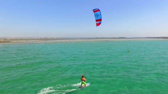 A man kiteboarding on a hydrofoil kite board.