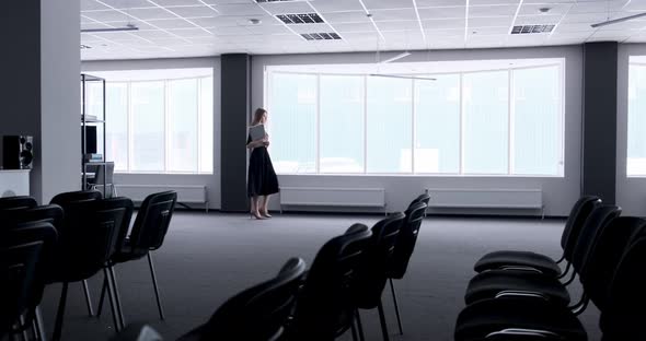 Silhouette of Young Business Woman Walking in Office Hall Corridor. Serious Attractive Female Goes