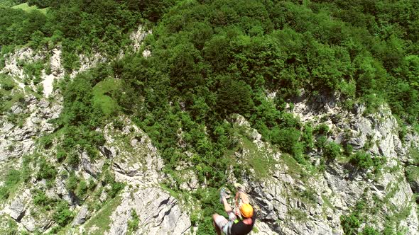 Aerial view of a person canopying over the forest in zip-line at Slovenia.