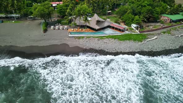 BEACH BUNGALOW ON DARK ROCK SAND