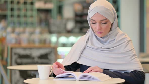 Studious Young Arab Woman Reading Book