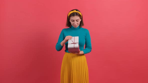 Woman Opening Box and Expressing Great Disappointment