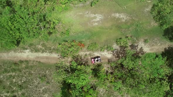 Aerial view two quadricycles doing trail next Chocolate Hills Complex, Batuan.