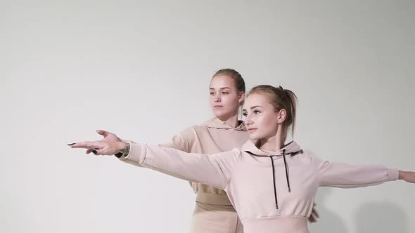 Girl doing fitness in Studio. instructor helps perform yoga exercises correctly