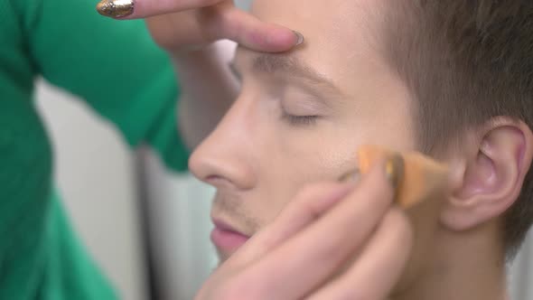 Visagist Applying Foundation Male Face