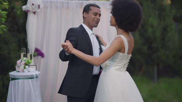 Slow Dance of Happy Couple of Newlyweds at Wedding Altar Outdoors