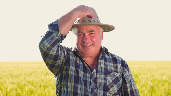 Happy Farm Worker Putting on Hat