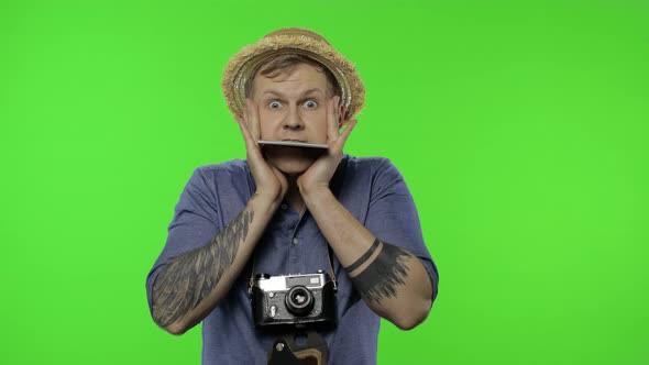 Portrait of Young Man Tourist Photographer Looking Shocked. Chroma Key