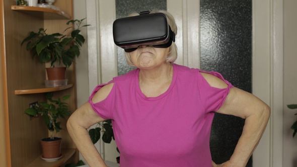 Senior Grandmother Woman in Virtual Headset Glasses Watching 3d Video in 360 Vr Helmet at Home