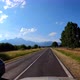 POV shot of driving a car on the road along the forest and mountains. Traveling in the summer by car - VideoHive Item for Sale