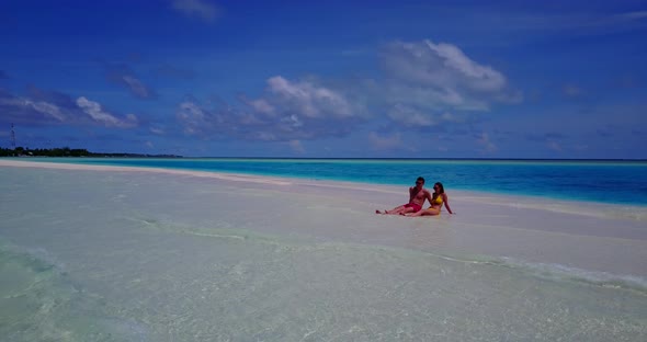 Young couple in love dating on vacation enjoy life on beach on clean white sand background 4K