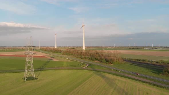 Scenery Of Green Fields With Country Road And Wind Turbines In Flevoland, Netherlands. Aerial Drone