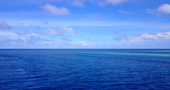 Luxury drone copy space shot of a white sandy paradise beach and blue ocean background in colorful