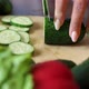 Closeup of Cook Cutting Fresh Cucumber on Wooden Chopping Board - VideoHive Item for Sale