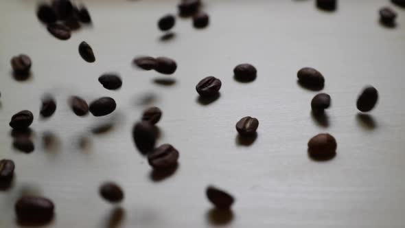 Full bag of coffee beans droped on working desk captured in slowed motion