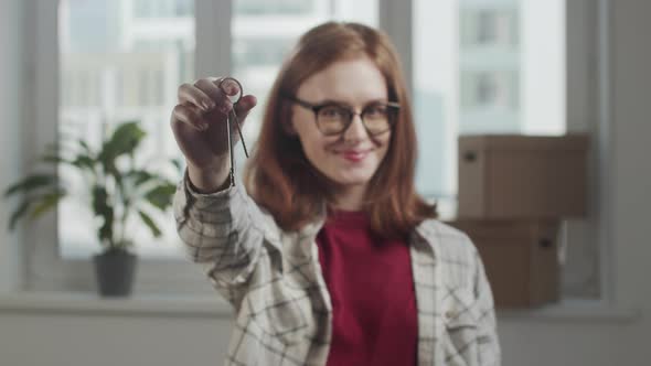 Young Woman Shakes Apartment Keys and Smiles in Slow Motion