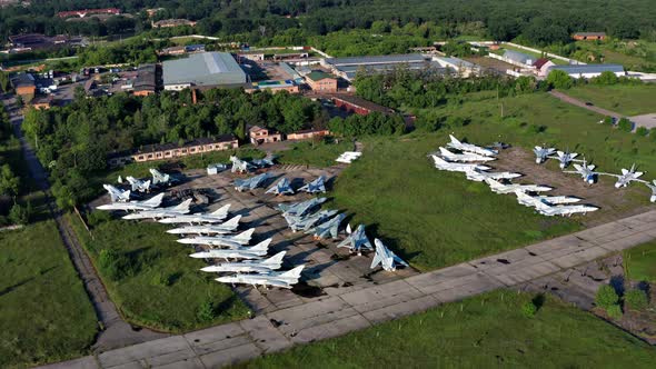 Top view of the planes at the airfield. Many old, broken aircraft are at the airfield. alt