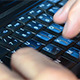 Man Typing Fast on a Black Laptop - VideoHive Item for Sale