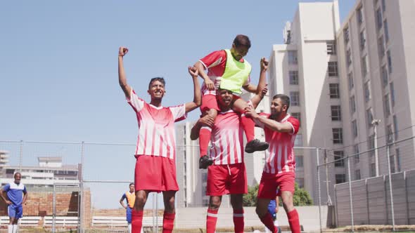 Soccer players celebrating on field