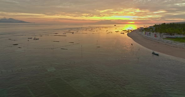 Sunrise at Pantai Pasir Putih point on Nusa Lembongan island, aerial