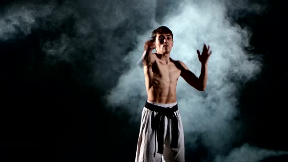 Man Practicing Karate or Kung Fu. Master Holding Nunchuck. Close Up