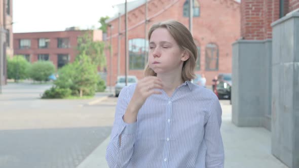 Woman Feeling Disappointed While Walking in Street