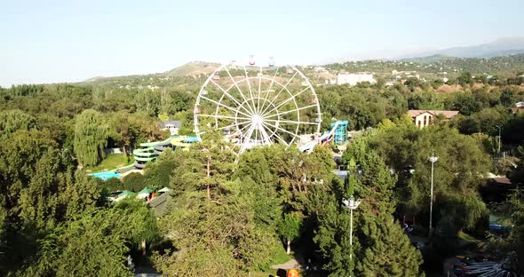 A City Park with Rides and a Ferris Wheel