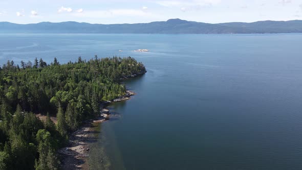 Beautiful, deep blue ocean surrounding Canoe Bay Beach and the Sunshine Coast in British Columbia, C