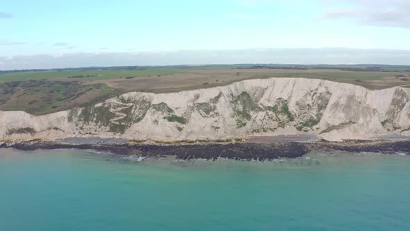 close up Aerial drone shot towards the white cliffs of dover over the sea