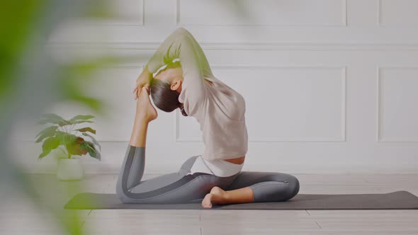 Side view of Asian woman doing Yoga exercise,Yoga One Legged King Pigeon