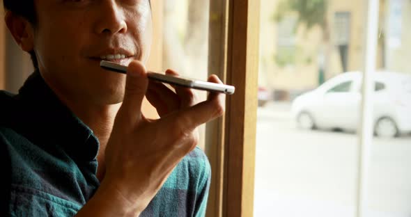 Man talking on mobile phone in the cafe 