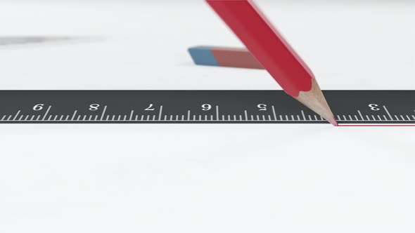 Red Pencil Draws a Line Along the Ruler