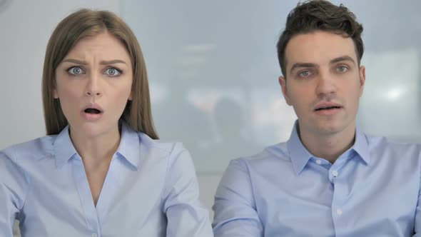 Young Business Colleagues in Shock By Results Wondering