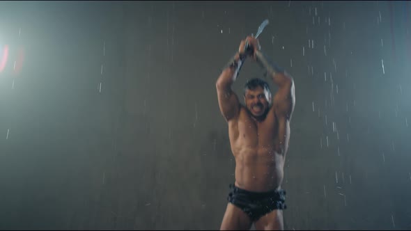Shirtless Gladiator Jumping in Attack Under Rain.