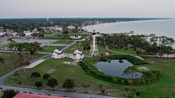 Aerial flight towards the Cape San Blas lighthouse relocated to Port St. Joe Florida showing the bay