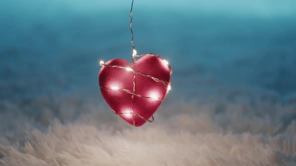 Red heart hanging on the white carpet