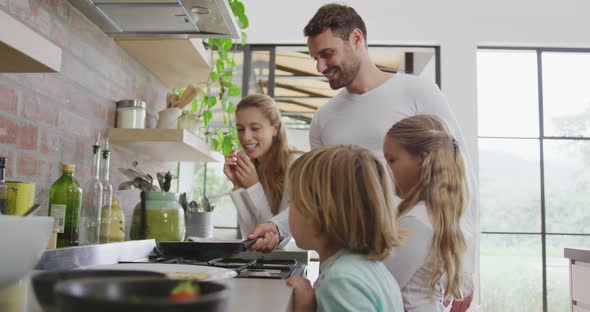 Family preparing food in kitchen at home 4k