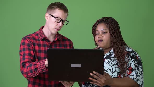 Overweight African Woman and Young Scandinavian Man Together Against Green Background