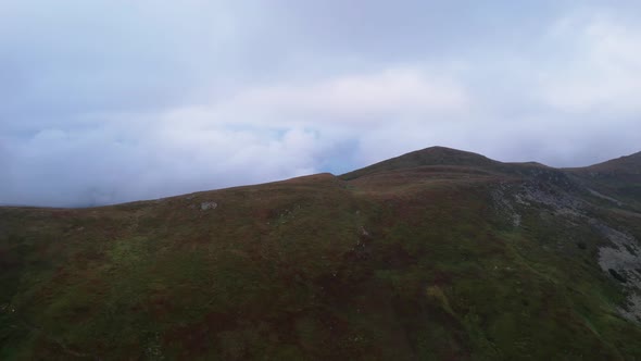 Aerial View of the Mountain Range at Dawn in a Drone Flight in the Clouds