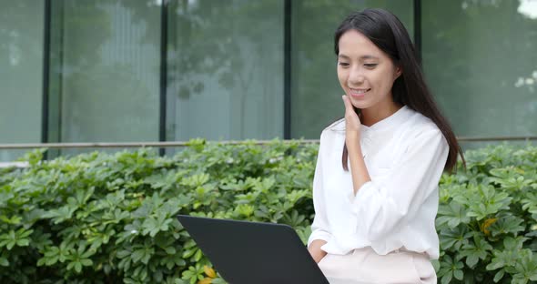 Business woman use of notebook computer at city