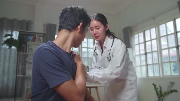 Medical Nurse In Safety Gloves Is Making A Vaccine Injection To A Male Patient In A Health Clinic